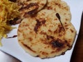 Pupusa or tortilla stuffed with cheese on plate with cabbage