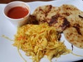 Pupusa or tortilla stuffed with cheese on plate with cabbage and tomato sauce