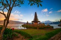 Pura Ulun Danu Bratan temple. Balinese landmark. Foreground with tree and green grass. Bratan lake, Bedugul, Bali, Indonesia Royalty Free Stock Photo