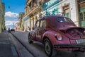 A purble oldtimer beetle in the streets of santiago de cuba