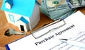 Purchase agreement document with home model. Royalty Free Stock Photo