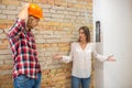 Purchaser talking to the construction worker and looking unpleased