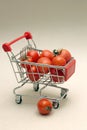 Purchases. Little shopping trolley with tomatoes