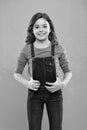 Pure beauty. Little girl with long hair. Kid happy cute face with adorable curly hair stand over blue background. Beauty Royalty Free Stock Photo