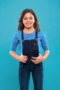 Pure beauty. Little girl with long hair. Kid happy cute face with adorable curly hair stand over blue background. Beauty Royalty Free Stock Photo