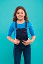 Pure beauty. Little girl with long hair. Kid happy cute face with adorable curly hair stand over blue background. Beauty Royalty Free Stock Photo