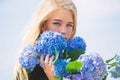 Pure beauty. Tenderness of young skin. Springtime bloom. Girl tender blonde hold hydrangea flowers bouquet. Natural