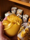 Natural handcrafted beeswax candle. Beewax candle baby dragon in egg. Mythology creature.