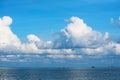 Pure clear blue sky huge white gray cloud and sunlight shiny on tropical on the sea and fishing boat Royalty Free Stock Photo