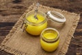 Pure or desi ghee ghi, clarified melted butter. Healthy fats bulletproof diet concept or paleo style plan. Glass jar, silver