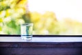 Pure fresh water in a glass glass on a wooden table on a green natural background Royalty Free Stock Photo