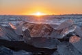 Pure Ice Shining on Black Volcanic Sand at Sunset. Icebergs from Glacier in Sun Rays. Clear Ice in Ocean Waves. Famous Royalty Free Stock Photo