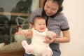 pure joy as a young Asian Korean mother lovingly plays with her little baby girl, creating a lasting affection happiness bond - Royalty Free Stock Photo