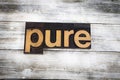 Pure Letterpress Word on Wooden Background Royalty Free Stock Photo