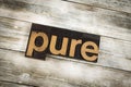 Pure Letterpress Word on Wooden Background Royalty Free Stock Photo