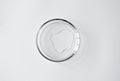 Pure liquid spot in glass petri dish on white background with copy space, top view. Concept science