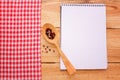 Pure notebook for recording menu, recipe on red checkered tablecloth tartan. Royalty Free Stock Photo