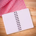 Pure notebook for recording menu, recipe on red checkered tablecloth tartan. Royalty Free Stock Photo