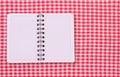 Pure notebook for recording menu, recipe on red checkered tablecloth tartan. Royalty Free Stock Photo