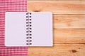 Pure notebook for recording menu, recipe on red checkered tablecloth tartan. Royalty Free Stock Photo