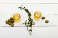 Pure olive oil and green olives on wooden surface Royalty Free Stock Photo