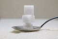 Pure refined sugar and sugar cubes on spoon. Sweet food ingredient, the diet health risks related to diabetes and calorie intake. Royalty Free Stock Photo