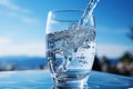 Pure, refreshing drinking water in a sparkling clear glass against a serene soft blue background Royalty Free Stock Photo