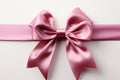 Pure sophistication white background highlights pink ribbon embellished with a graceful bow