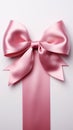 Pure sophistication white background highlights pink ribbon embellished with a graceful bow