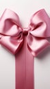 Pure sophistication white background highlights pink ribbon embellished with a graceful bow