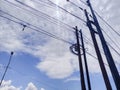 pure white clouds in a bright blue sky above a power pole Royalty Free Stock Photo