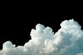 Pure white cumulus clouds on black background. Cloudscape background. White fluffy clouds on dark background. Soft cotton feel of Royalty Free Stock Photo