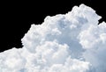 Pure white cumulus clouds on black background. Cloudscape background. White fluffy clouds on dark background. Soft cotton feel of Royalty Free Stock Photo