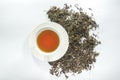Pure white cup of tea and dried tea leaf Royalty Free Stock Photo
