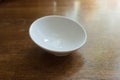 Pure white porcelain bowl on wooden table