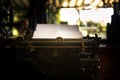 Pure white paper is in an old black rustic typewriter. The typewriter is ready for the writer to write new text using it