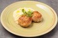 Puree with butter and chicken cutlets decorated with a parsley leaf