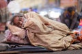 Homeless Indian man sleeping in the street