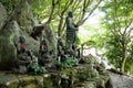 Purification fountain in the sunlighted garden of Daishoin shrine, Miyajima, Japan Royalty Free Stock Photo