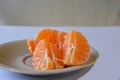 Purified mandarin on the light surface of the table Royalty Free Stock Photo