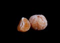 Purified mandarin and a slice of mandarin are isolated on a black background