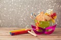 Purim carnival celebration with hamantaschen cookies and grogger Royalty Free Stock Photo