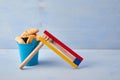 Purim celebration concept with hamantashen cookies, Purim toy noisemaker on blue background