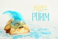 Purim celebration concept & x28;jewish carnival holiday& x29;. Traditional hamantaschen cookies with beautiful blue and gold mask Royalty Free Stock Photo