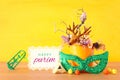 Purim celebration image jewish carnival holiday with traditional hamantasch cookies and deer antlers floral decoration over