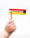 Purim. A child's hand holding Colorful wooden noisemaker