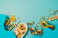 Purim holiday concept with carnival mask, noisemaker and hamantaschen cookies on blue background. Top view, flat lay Royalty Free Stock Photo