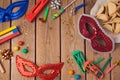 Purim holiday concept celebration with carnival mask on wooden background.