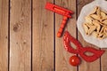 Purim holiday concept celebration with clown mask and hamantaschen cookies on wooden background.