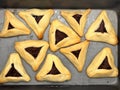 Purim jewish holiday cookies backed Hamentashen Ozen Haman in baking oven tray